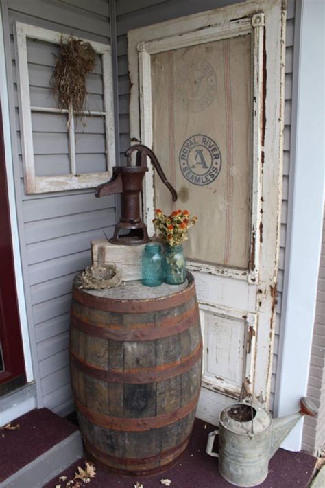 Primitive outdoor decorating. Whiskey Barrel, Old door, feed sack ...