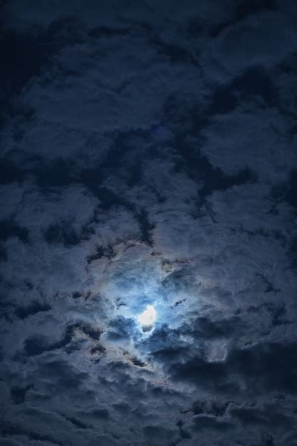 Premium Photo | Full moon in the clouds in the night sky