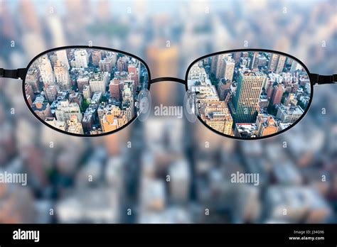 Clear cityscape focused in glasses lenses with blurred cityscape Stock Photo: 139627522 - Alamy