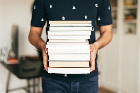 Person Holding Stack of Books · Free Stock Photo