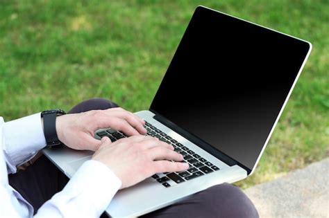 Premium Photo | Young man with laptop outdoors