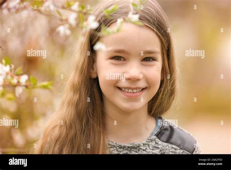 Cute little girl walking in spring park Stock Photo - Alamy