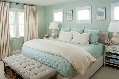 HGTV loves this dreamy coastal bedroom with seafoam green walls, pale blue bedding and creamy ...