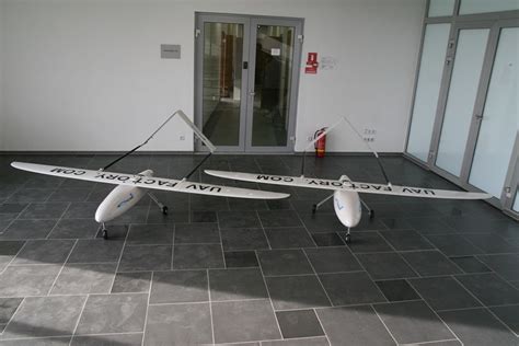 two white surfboards sitting on top of a tiled floor