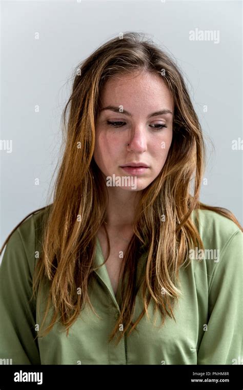 Portrait of a young woman looking downwards. Medium close up Stock ...