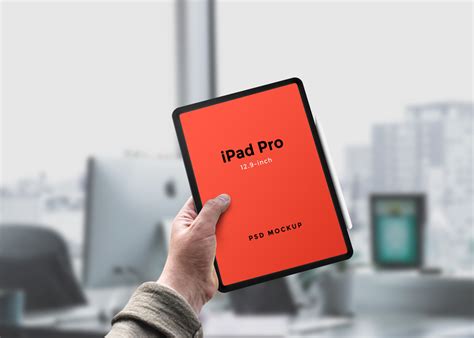 Hand holding iPad Pro Mockup - Mockup World