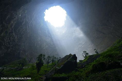 WSJ Photos on Twitter: "In China, a sinkhole more than 317 yards deep has become home to plants ...