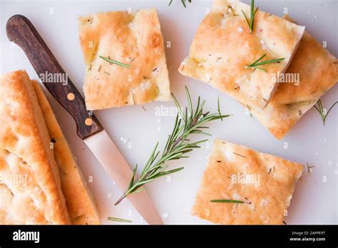 Simple plane pizza with rosemary and salt cut in pieces Stock Photo - Alamy