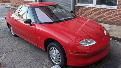 Rare GM EV1 electric car survivor converted to a hybrid, parked outside