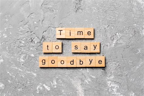 Time To Say Goodbye Word Written on Wood Block. Time To Say Goodbye Text on Cement Table for ...