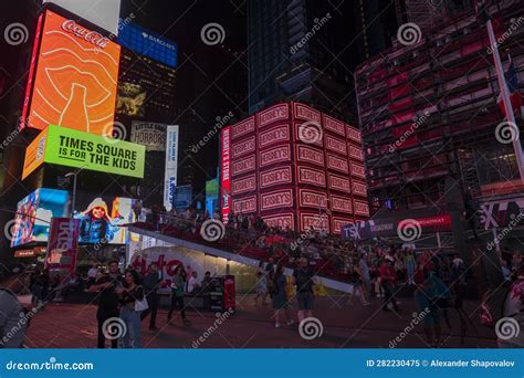 Beautiful Night View of Red Stairs on Times Square in New York with People Walking. New York ...