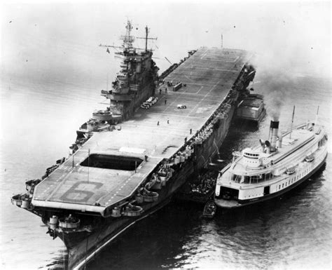 Battered but victorious, USS Enterprise (CV-6) transfers crew to the ferry City of Sacramento in ...