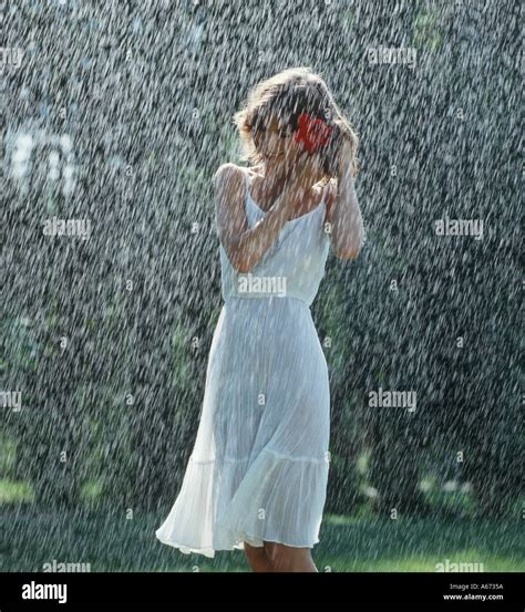 Girl walking alone in rain in park Stock Photo - Alamy