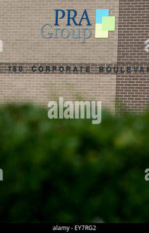 A logo sign outside of the headquarters of the PRA Group, Inc., also ...