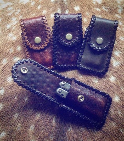 Leatherman belt pouches with laced edges.