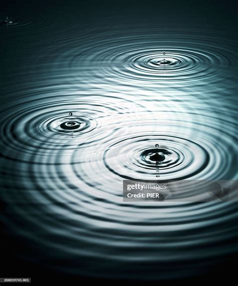 Water Droplets Creating Ripples On Surface Of Water High-Res Stock ...