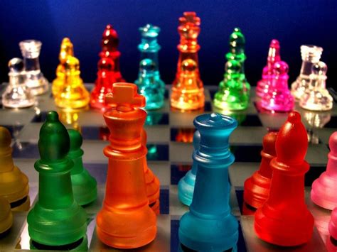 a colorful chess board with the pieces in all different colors and sizes on it's sides