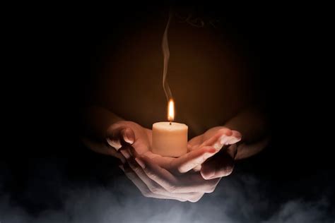 Premium Photo | Hands holding candle