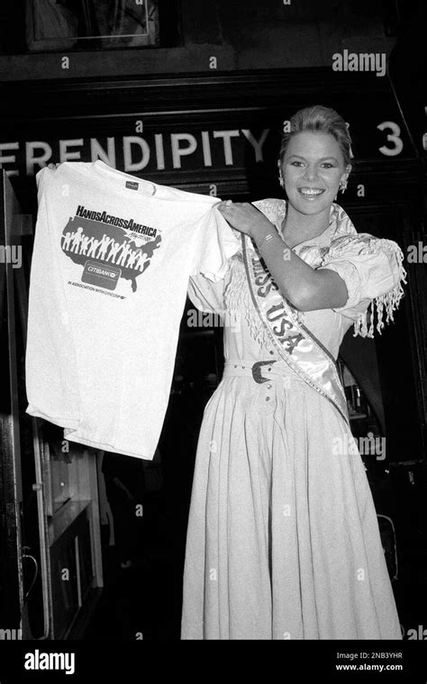 Miss USA Christy Fichtner holds up a “Hands Across America” T-shirt in ...