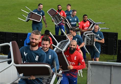 England's players and staff carry their chairs back after the team ...