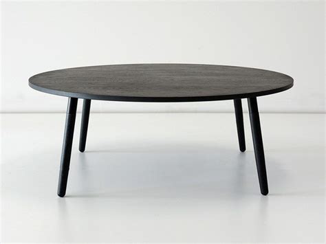 a round table with black legs on a white background