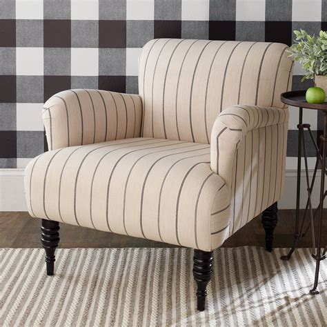 This arm chair features curved arms, a plush seat and spool legs in trending black or gray. A ...