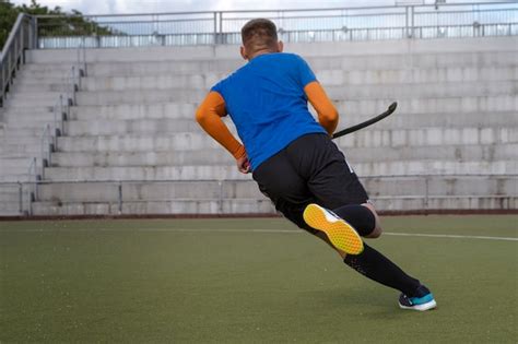 Free Photo | Field hockey player in equipment on the grass