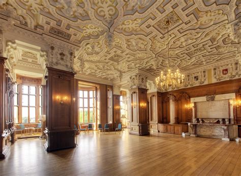 an ornate room with wooden floors and chandeliers