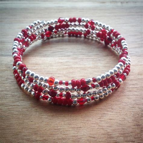 Beaded memory wire bracelet - silver beads, red beads and seed beads and swarovski crystal beads ...