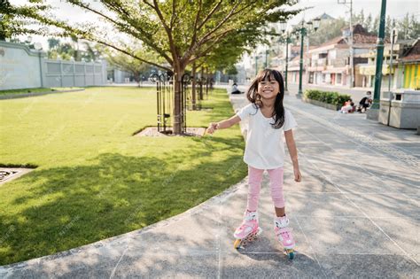 Premium Photo | Portrait of a cheerful little girl in the park