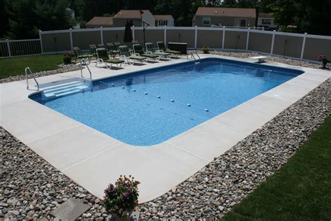 Rectangle style pool with brushed concrete decking. http://www.reginapools.com/gallerypool ...