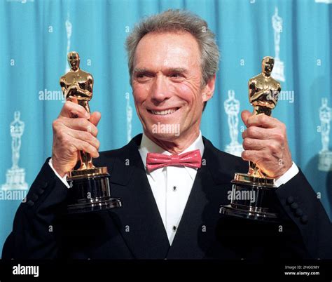 Clint Eastwood holds up his two Oscars at the Academy Awards in Los ...