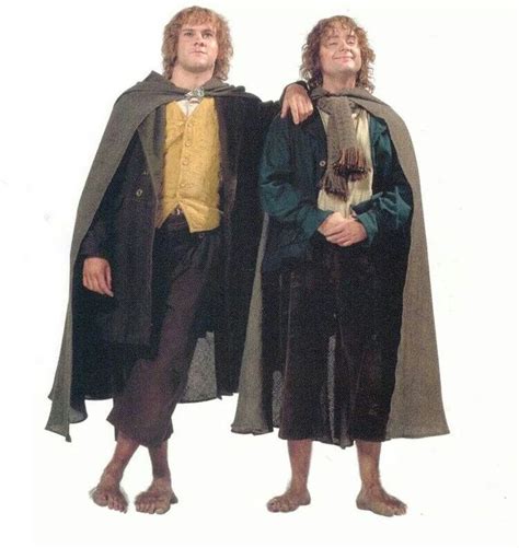 two men dressed in medieval clothing standing next to each other with capes over their heads