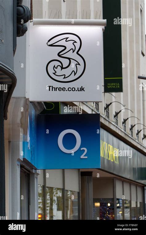 Three & O2 mobile network brand logos on high street Stock Photo - Alamy