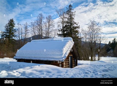 Rustic Log Cabin in Winter. A winter landscape with a rustic snow ...