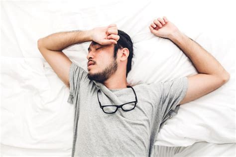 Premium Photo | Tired man sleeping on bed