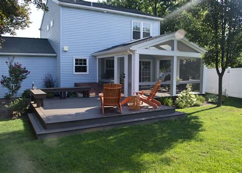 This Custom TimberTech deck and porch was constructed using Mocha decking. The screened in porch ...