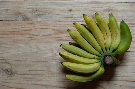 Premium Photo | Ambon banana is Musa acuminata Cavendish Subgroup bananas on a brown wooden ...