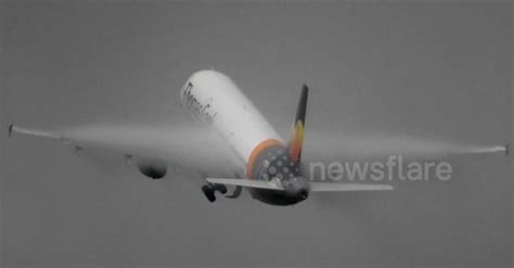 Condensation clouds engulf plane's wings as it takes off from Manchester Airport - Sharedots