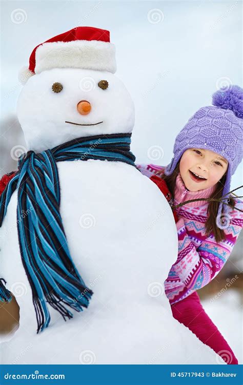 Kid playing with snowman stock image. Image of cute, pretty - 45717943