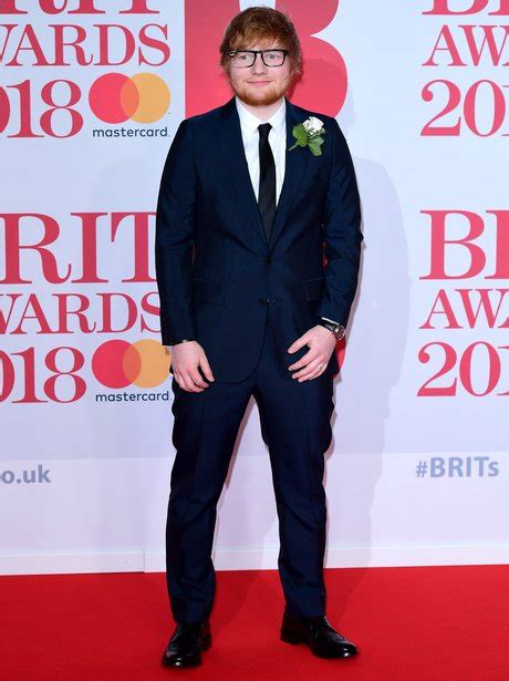 Ed Sheeran is working this navy suit and we see that little band on his ...