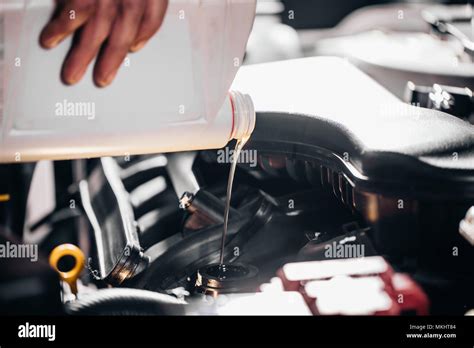 Pouring oil to car engine, close up Stock Photo - Alamy