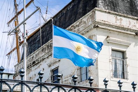 Premium Photo | Argentinean flag on the background of an old historical building Blue and white ...