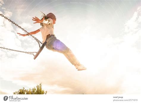 Child jumps off swing - a Royalty Free Stock Photo from Photocase