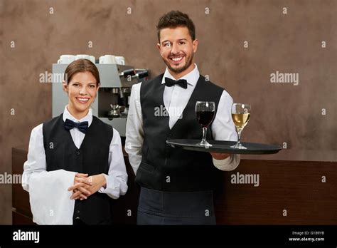 Waiter and waitress serving drinks in a hotel restaurant Stock Photo ...