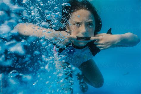 "Young Preteen Girl Having Fun Swimming In A Pool Underwater" by Stocksy Contributor "Robert ...