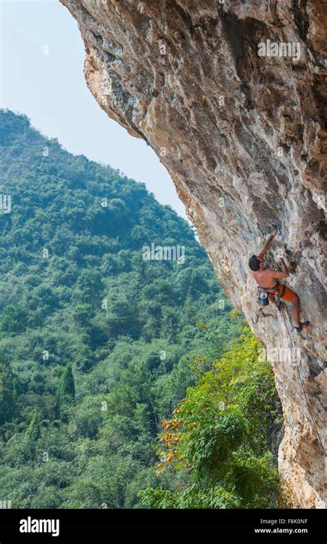 Male climber climbing at Odin's Den next to Moon Hill in Yangshuo, Guangxi Zhuang, China Stock ...