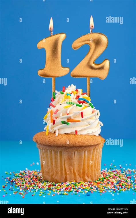 Birthday cake with candle number 12 - Blue background Stock Photo - Alamy