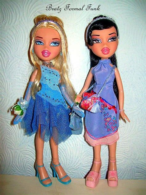 two dolls are standing next to each other