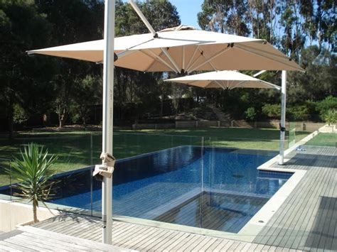 Two square cantilever umbrellas providing great shade coverage over a pool | Pool shade ...